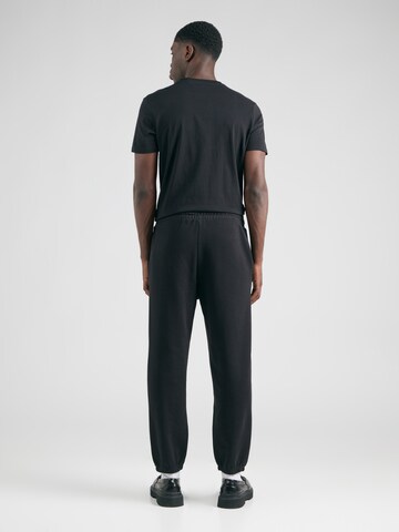 Tapered Pantaloni 'Dacusi' di HUGO in nero