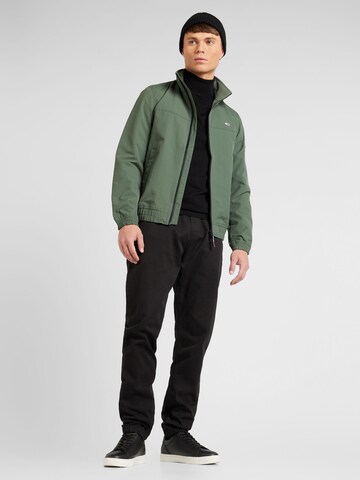 Tommy Jeans Between-Season Jacket 'ESSENTIAL' in Green