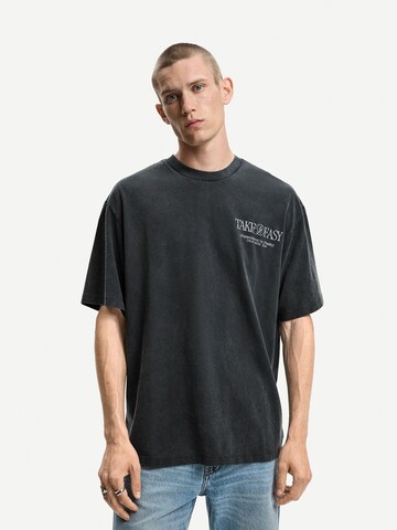 T-Shirt 'SURREAL' Bershka en noir