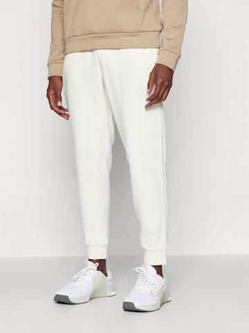 NIKE Tapered Sports trousers 'PRIMARY' in Beige: front