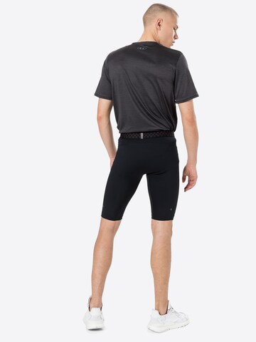 Skinny Pantalon de sport UNDER ARMOUR en noir