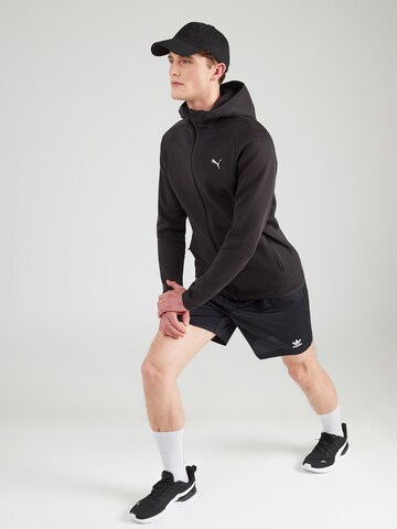 Bluză cu fermoar sport 'Evostripe' de la PUMA pe negru