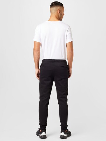 Champion Authentic Athletic Apparel Tapered Sporthose in Schwarz