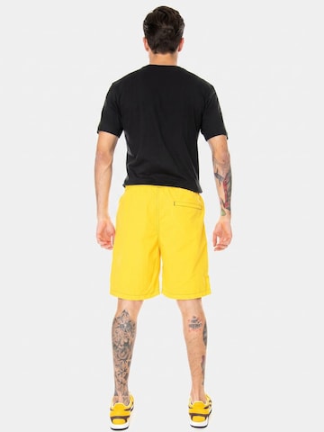 Carhartt WIP Luźne Spodnie 'Kastor Short Sunflower / Black' w kolorze żółty