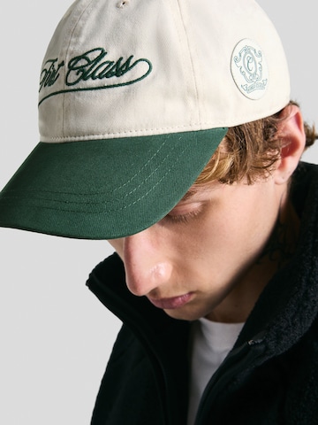 Casquette 'FIRST CLASS' Bershka en beige