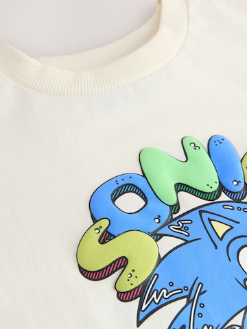 Tricou de la Next pe bej