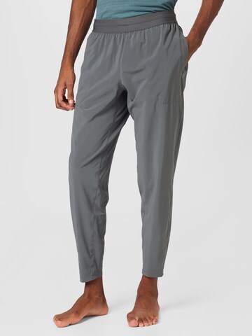 NIKE Tapered Workout Pants in Grey: front