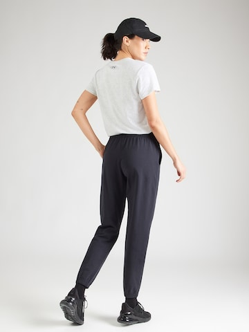 UNDER ARMOUR Tapered Sports trousers in Black