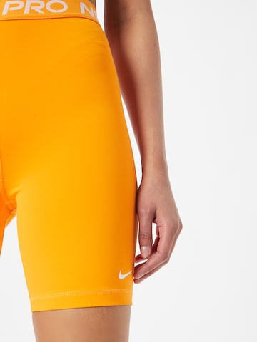 NIKE Skinny Sportbroek 'Pro 365' in Oranje