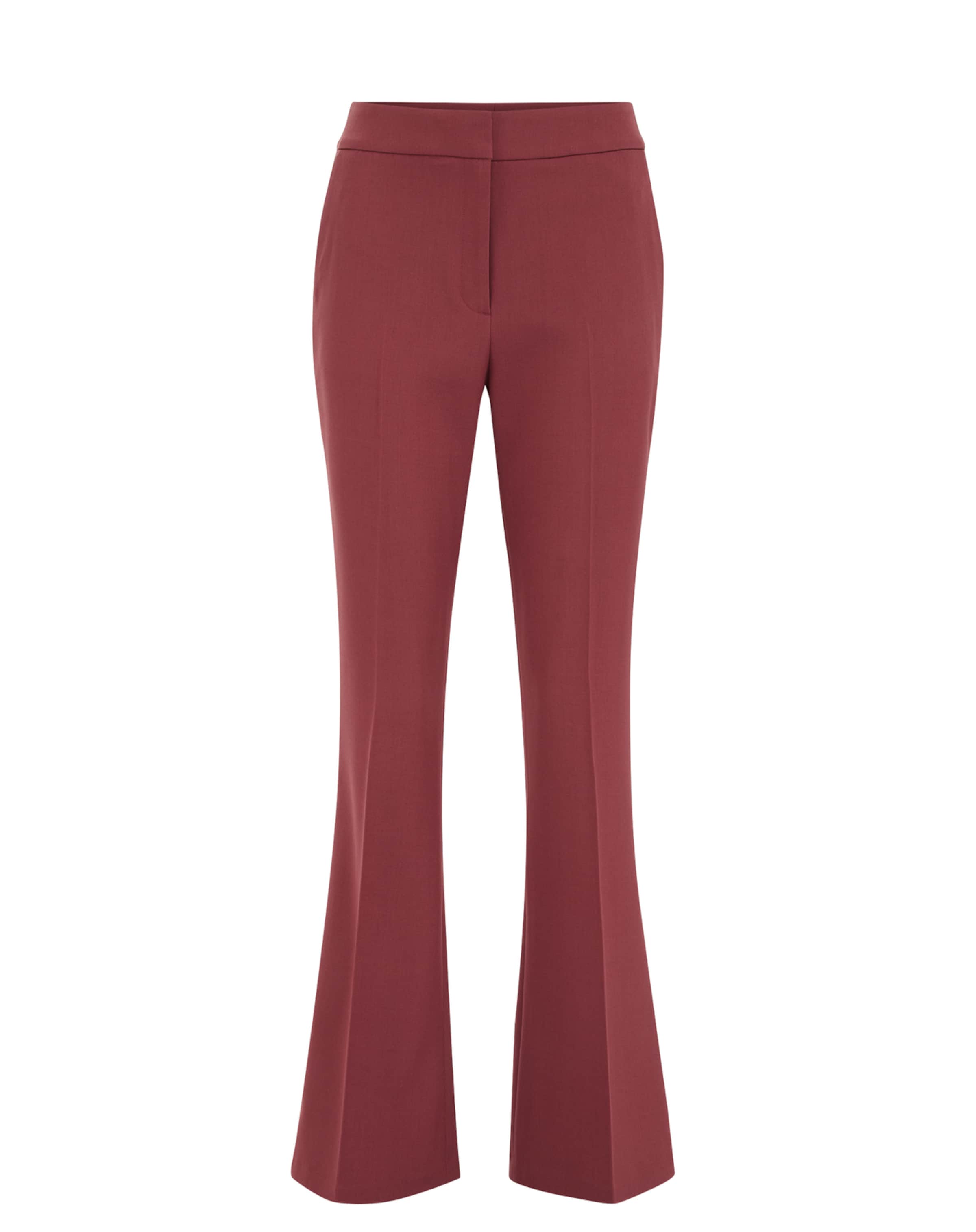 Flared Pantaloni con piega frontale di WE Fashion in rosso: frontale