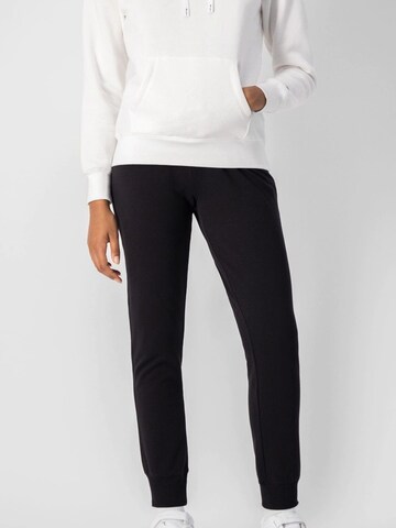 Tapered Pantaloni di Champion Authentic Athletic Apparel in nero