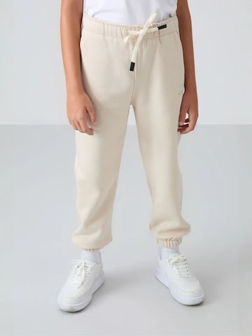 Tommy Life Broek 'TOMMY Kinder Jogginghose' in Beige: voorkant