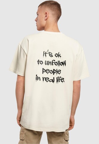T-Shirt 'Unfollow' Merchcode en beige