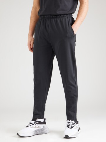 Champion Authentic Athletic Apparel - Tapered Pantalón deportivo en negro: frente