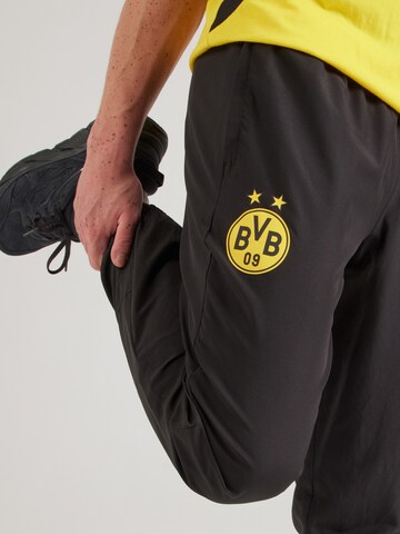 PUMA - Tapered Pantalón deportivo 'Borussia Dortmund FtblArchive' en negro