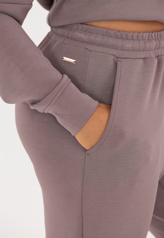 Athlecia Tapered Sports trousers 'Jacey' in Brown