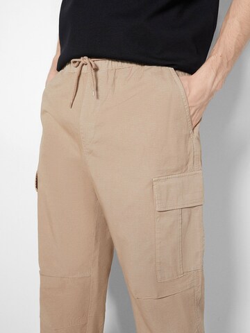 Bershka Loose fit Cargo trousers in Beige