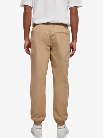 Tapered Pantaloni di Urban Classics in beige