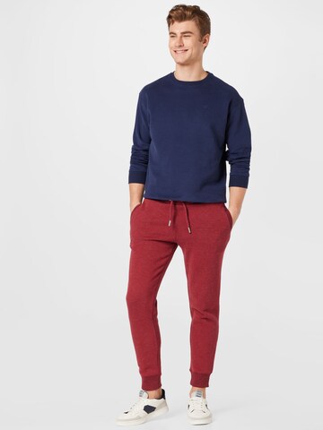 Tapered Pantaloni di Superdry in rosso