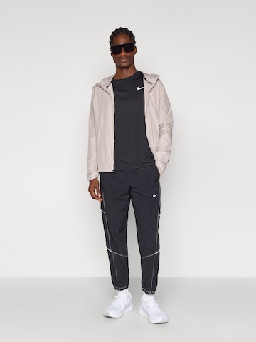 Tapered Pantaloni sportivi 'RETRO' di NIKE in nero