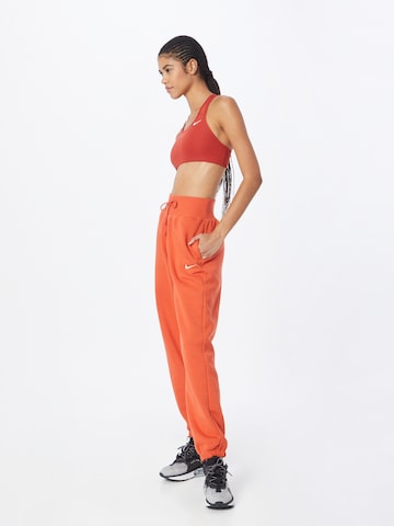 Nike Sportswear Tapered Pants 'Phoenix Fleece' in Orange