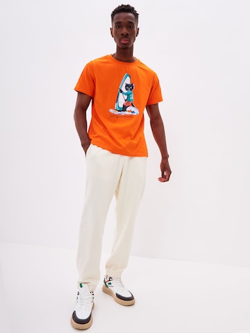 T-Shirt 'SURFER CAT' CAT by Maniita Lacitta en orange