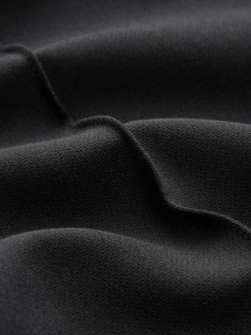 Flared Pantaloni con piega frontale di Next in nero
