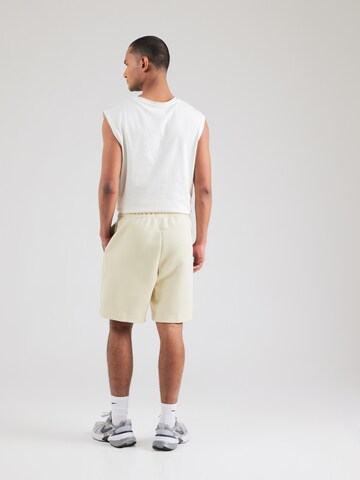 Nike Sportswear Loosefit Nadrág 'TCH FLC' - zöld