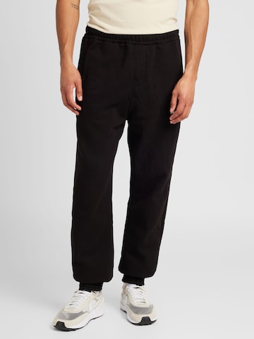 Pegador Tapered Trousers in Black: front