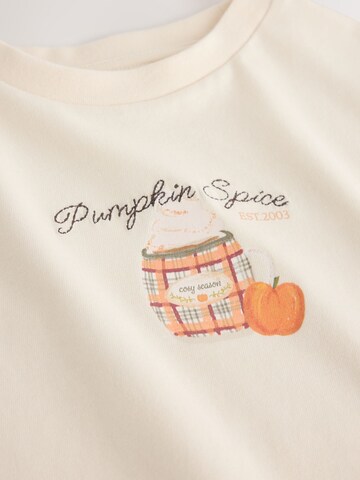 Tricou de la Next pe bej