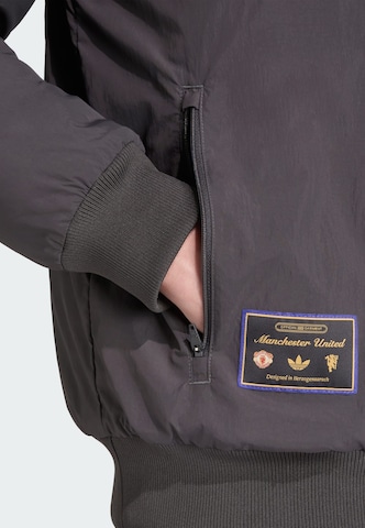 Veste fonctionnelle 'Manchester United Terrace Icons' ADIDAS ORIGINALS en noir