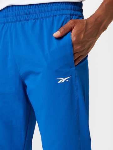 Reebok Štandardný strih Športové nohavice - Modrá