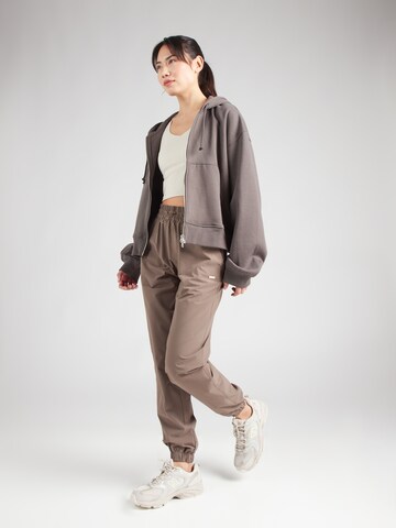 Athlecia Tapered Sports trousers 'Hero' in Brown