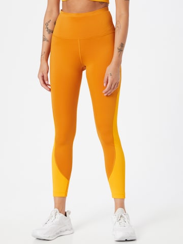 Reebok Skinny Workout Pants in Orange: front