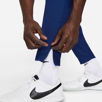 NIKE Tapered Workout Pants in Blue