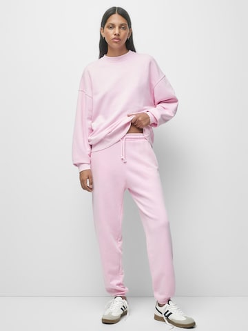 Pull&Bear Zwężany krój Spodnie w kolorze różowy: przód