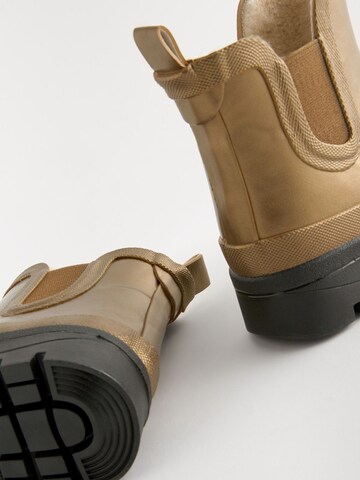 Next - Botas de lluvia en oro