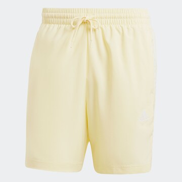 ADIDAS SPORTSWEAR Workout Pants 'Essentials Chelsea' in Yellow: front