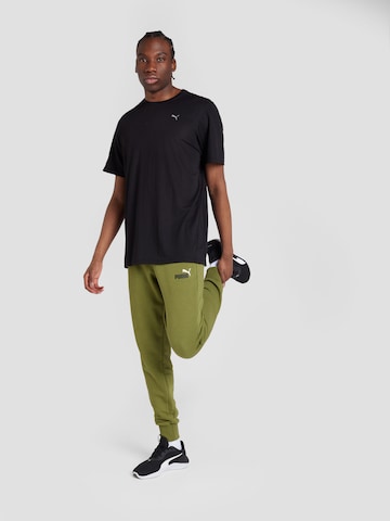 PUMA Zwężany krój Spodnie sportowe 'ESS+' w kolorze zielony