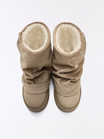 Boots Bershka en beige : au dessus