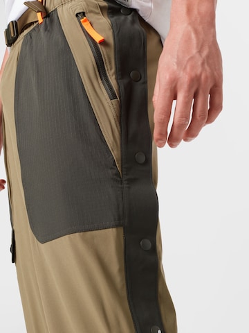 UNDER ARMOUR Tapered Sportsbukser 'Rush' i grøn