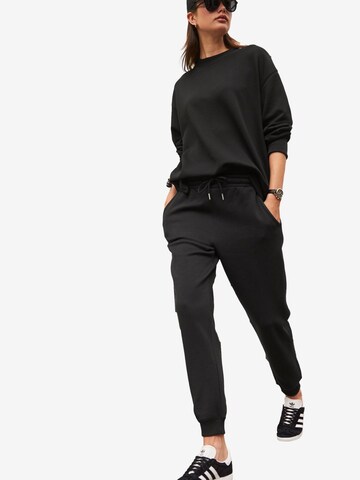 Next - Tapered Pantalón en negro
