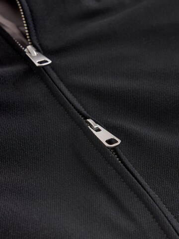 Next - Chaqueta de entretiempo 'Motionflex' en negro