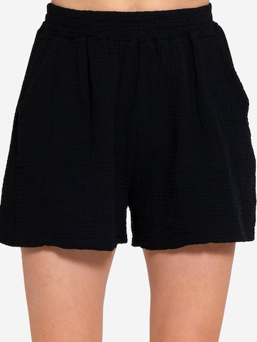 SASSYCLASSY Loose fit Trousers in Black: front