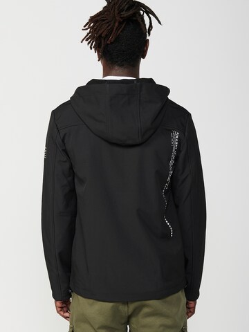 KOROSHI Välikausitakki värissä musta