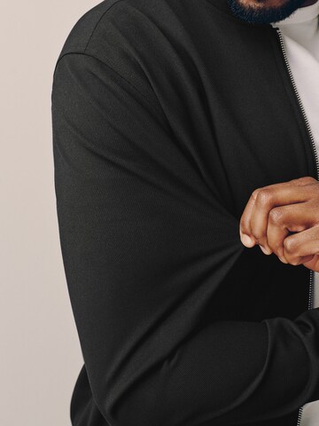 Next - Chaqueta de entretiempo 'Motionflex' en negro