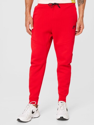 raudona Nike Sportswear Siaurėjantis Kelnės 'Tech Fleece': priekis
