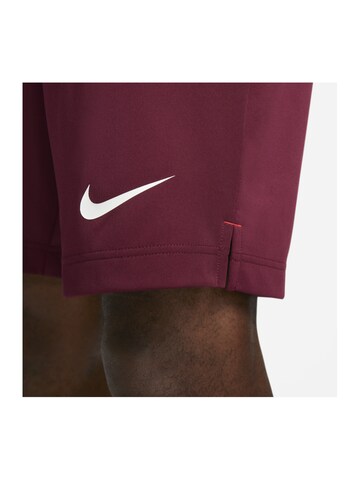 NIKE Regular Sports trousers in Red