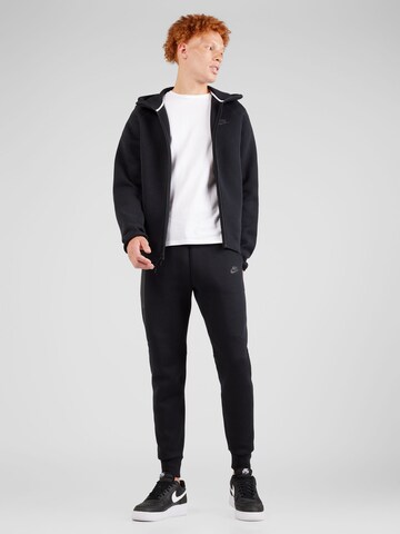 Nike Sportswear Tapered Housut 'TECH FLEECE' värissä musta