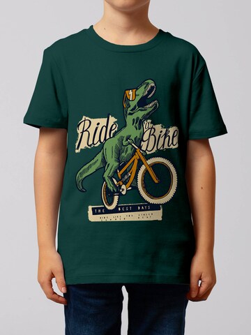 watabout.kids Shirt 'T-Rex Fahrrad' in Groen: voorkant